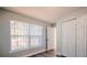 Bright bedroom with a large window, wood laminate flooring, and a double door closet at 1017 Winding Water Way, Clermont, FL 34714