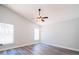 Large bedroom with vaulted ceiling, ceiling fan, and wood look floors at 1017 Winding Water Way, Clermont, FL 34714