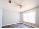 Neutral bedroom featuring ceiling fan, wood look floors and large window at 1017 Winding Water Way, Clermont, FL 34714