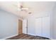 Neutral bedroom with ceiling fan, wood look floors and large closet at 1017 Winding Water Way, Clermont, FL 34714