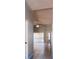 Spacious hallway with tile flooring leading to the living areas, and natural light through sliding glass doors at 1017 Winding Water Way, Clermont, FL 34714