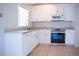 Bright kitchen features stainless steel appliances, granite counters, and modern white cabinetry at 1017 Winding Water Way, Clermont, FL 34714