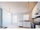 Sunlit kitchen features stainless steel appliances, granite countertops, and white cabinetry at 1017 Winding Water Way, Clermont, FL 34714
