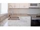 Close-up of stainless steel kitchen sink, granite counters and stainless steel appliances at 1017 Winding Water Way, Clermont, FL 34714