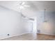Open living room with tile flooring, vaulted ceilings, neutral paint, and modern light fixtures at 1017 Winding Water Way, Clermont, FL 34714