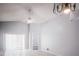 Open living area with tile floors, vaulted ceiling and fan, leading to the patio through sliding glass doors at 1017 Winding Water Way, Clermont, FL 34714