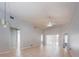 Bright living room featuring tile floors, a vaulted ceiling with fan, and sliding glass doors to the outdoors at 1017 Winding Water Way, Clermont, FL 34714