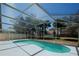 The refreshing screened-in pool is surrounded by a spacious backyard at 1017 Winding Water Way, Clermont, FL 34714