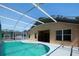 The crystal-clear pool has ample deck space and is fully screened for privacy at 1017 Winding Water Way, Clermont, FL 34714
