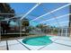 Sparkling swimming pool offers a refreshing retreat in the screened enclosure at 1017 Winding Water Way, Clermont, FL 34714