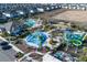 Aerial view of a community showcasing resort-style amenities with swimming pools, waterslides, and lounging areas, perfect for relaxation and fun at 1034 Splash Shot Pl, Davenport, FL 33896