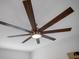 A modern eight-blade ceiling fan features a central light fixture, enhancing the room's aesthetic and providing ample illumination at 1034 Splash Shot Pl, Davenport, FL 33896