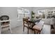 Bright dining room with a large table set, complemented by windows and tile flooring at 1034 Splash Shot Pl, Davenport, FL 33896