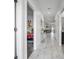 Inviting hallway with marble tile, views of the living room and Disney-themed bedroom providing a glimpse of Gathering life at 1034 Splash Shot Pl, Davenport, FL 33896