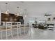 Open-concept kitchen with modern appliances, pendant lighting, and bar seating seamlessly connects to the living area at 1034 Splash Shot Pl, Davenport, FL 33896