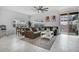 Spacious living room with tile flooring, comfortable seating, and access to outdoor patio for seamless indoor-outdoor living at 1034 Splash Shot Pl, Davenport, FL 33896