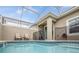 Inviting screened-in pool featuring cool, refreshing water and comfortable seating areas under a bright blue sky at 1034 Splash Shot Pl, Davenport, FL 33896