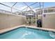 Private in-ground pool with screened enclosure, featuring patio furniture for outdoor enjoyment at 1034 Splash Shot Pl, Davenport, FL 33896