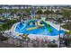 View of the community's splash pad with several slides and interactive water features, creating a vibrant and active recreational space at 1034 Splash Shot Pl, Davenport, FL 33896