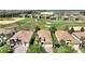 Aerial view of the property featuring a golf course view, mature trees, and well-manicured landscaping at 1335 Palmetto Dunes St, Davenport, FL 33836