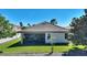 Rear view of a well-maintained home with a screened patio and lush green lawn at 1335 Palmetto Dunes St, Davenport, FL 33836