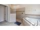 Bright bathroom featuring a glass-enclosed shower and a luxurious soaking tub with decorative tile accents at 1335 Palmetto Dunes St, Davenport, FL 33836