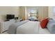 Comfortable bedroom with a large window, white furniture, and serene decor at 1335 Palmetto Dunes St, Davenport, FL 33836