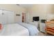 Well-lit bedroom featuring a closet, dresser, and desk at 1335 Palmetto Dunes St, Davenport, FL 33836