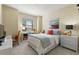 Cozy bedroom with natural light, decorated with warm colors, desk, and comfortable furnishings at 1335 Palmetto Dunes St, Davenport, FL 33836
