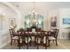 Formal dining room showcasing decorative chairs, elegant lighting, and a serving buffet with a mirror at 1335 Palmetto Dunes St, Davenport, FL 33836