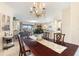 Open-concept dining room flows into the living area, showcasing decorative chandelier at 1335 Palmetto Dunes St, Davenport, FL 33836