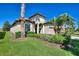 Attractive home exterior featuring lush landscaping and a well-manicured lawn at 1335 Palmetto Dunes St, Davenport, FL 33836