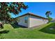 Beige exterior wall of home and green yard at 1335 Palmetto Dunes St, Davenport, FL 33836