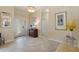 Bright foyer showcases decorative glass front door, tiled flooring, and a glimpse into the living spaces at 1335 Palmetto Dunes St, Davenport, FL 33836