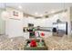 Bright kitchen featuring white cabinets, stainless appliances, and granite countertops at 1335 Palmetto Dunes St, Davenport, FL 33836