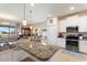 Well-lit kitchen with granite counters, stainless steel appliances, and white cabinetry at 1335 Palmetto Dunes St, Davenport, FL 33836