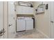 Functional laundry room equipped with modern washer and dryer, with storage cabinets at 1335 Palmetto Dunes St, Davenport, FL 33836