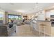 Spacious living area showcasing tile flooring, access to the lanai, and an open layout to the kitchen at 1335 Palmetto Dunes St, Davenport, FL 33836