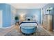 Comfortable main bedroom with natural light, blue walls, and modern decor at 1335 Palmetto Dunes St, Davenport, FL 33836
