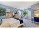 Bright main bedroom featuring blue walls, two dressers, and a window view at 1335 Palmetto Dunes St, Davenport, FL 33836