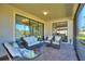 Cozy screened patio with comfortable seating, perfect for enjoying the outdoor scenery at 1335 Palmetto Dunes St, Davenport, FL 33836