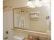 A bathroom with white tiled floors, a shower-tub, and a well-lit vanity for personal hygiene at 13427 Blue Heron Beach Dr # 1607, Orlando, FL 32821