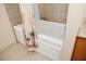Jacuzzi bathtub with tiled walls and a decorative shower curtain, with tile flooring at 13427 Blue Heron Beach Dr # 1607, Orlando, FL 32821