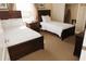 Bright bedroom with two twin beds, closet, and carpet flooring at 13427 Blue Heron Beach Dr # 1607, Orlando, FL 32821
