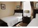 Comfortable bedroom featuring two twin beds, a bedside table, and a window with scenic views at 13427 Blue Heron Beach Dr # 1607, Orlando, FL 32821