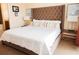 Inviting bedroom with a tufted headboard, patterned pillows, and side tables with lamps at 13427 Blue Heron Beach Dr # 1607, Orlando, FL 32821