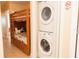 View of bunk beds with a Mickey Mouse themed pillow along with a stacked washer and dryer at 13427 Blue Heron Beach Dr # 1607, Orlando, FL 32821