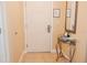 Welcoming entryway features beige walls, tiled flooring, and a decorative mirror and table at 13427 Blue Heron Beach Dr # 1607, Orlando, FL 32821