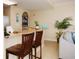 Kitchen with granite counter and bar seating open to the living area at 13427 Blue Heron Beach Dr # 1607, Orlando, FL 32821