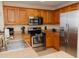 Kitchen features stainless steel appliances, wood cabinets, granite countertops and tile flooring at 13427 Blue Heron Beach Dr # 1607, Orlando, FL 32821